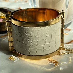 CC Skye Embossed leather cuff with pin and chain fastener